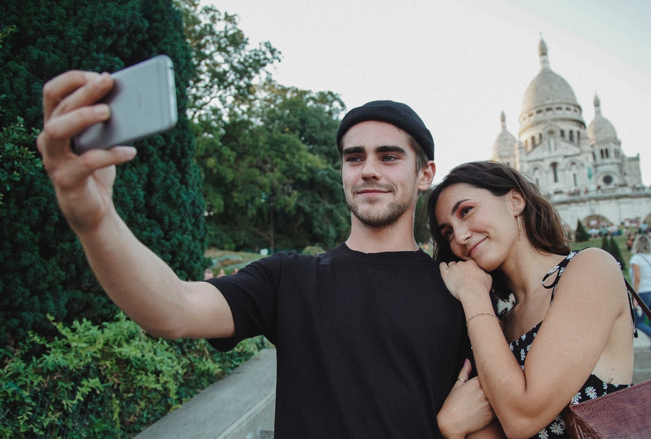 Man in Black Crew Neck T-shirt Beside Woman in a Floral Dress