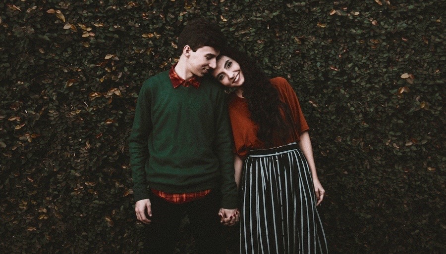 A happy man and woman standing right next to each other