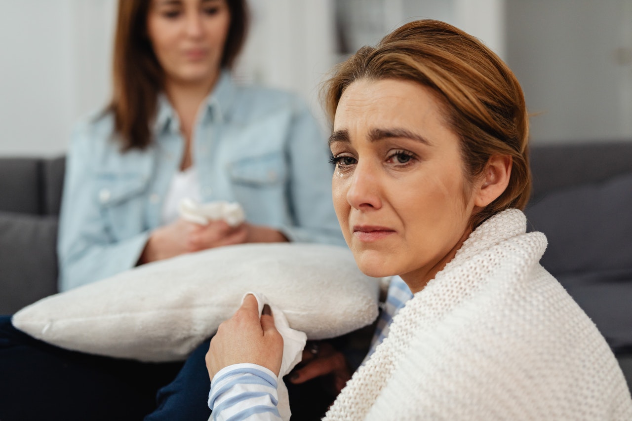 A Woman in White Sweater Crying With Tears