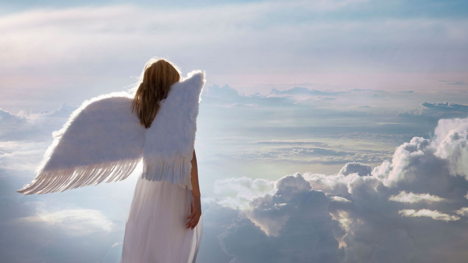 A Woman With Wings Standing On Clouds
