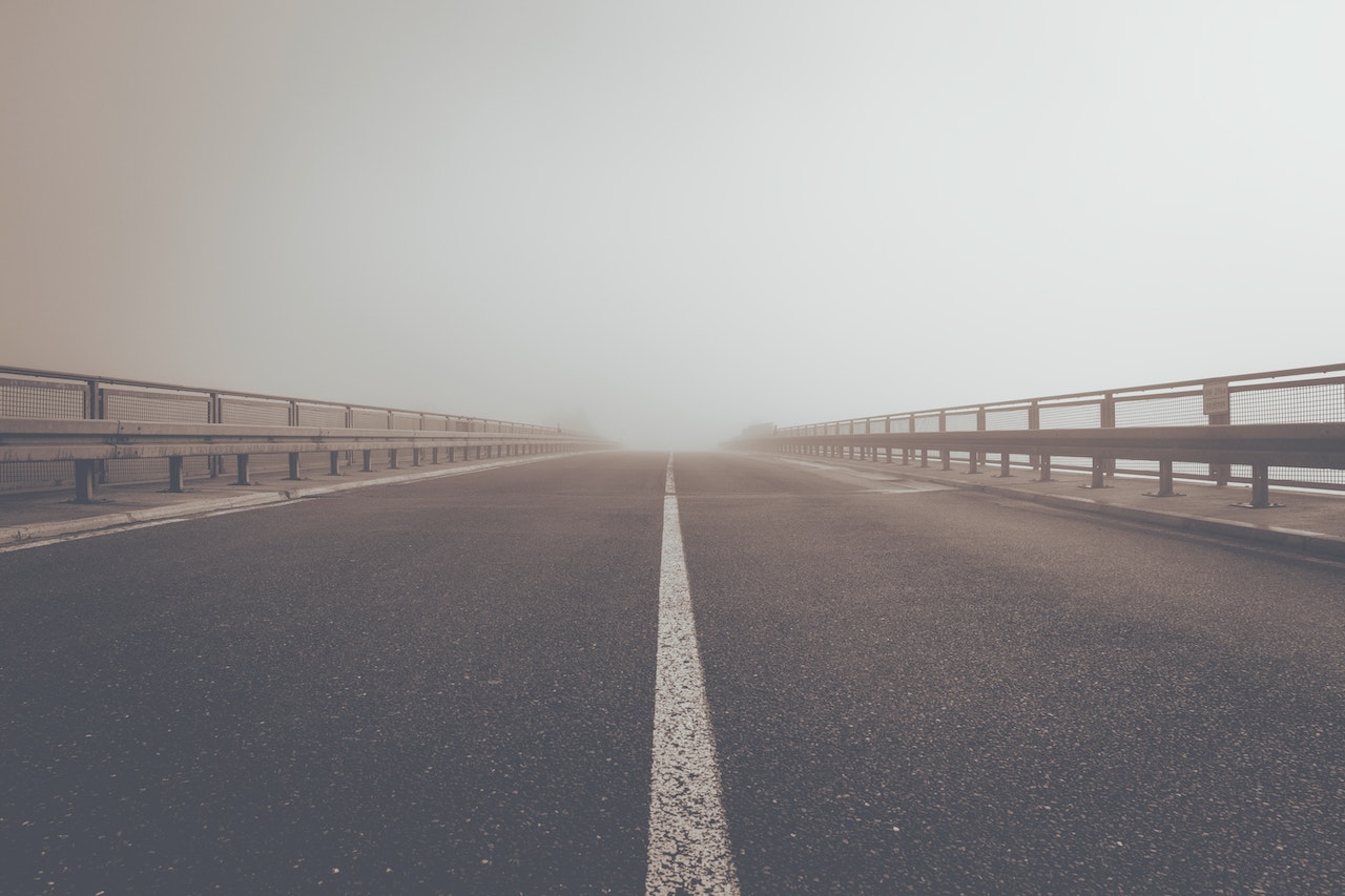 Gray Concrete Road Under Gray Sky