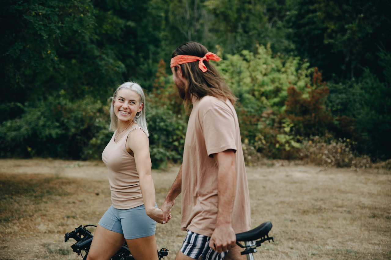 A Couple Walking while Holding Hands