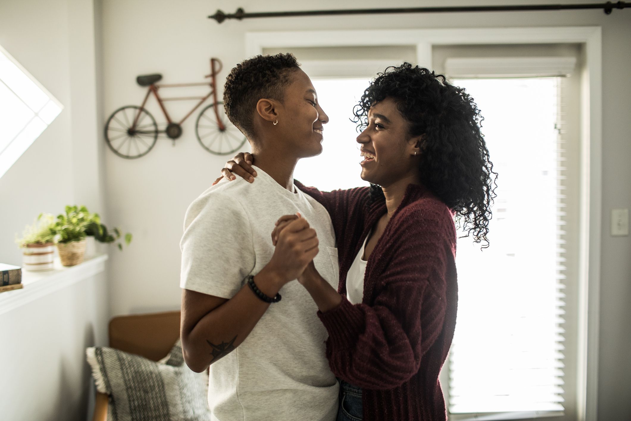 A couple dancing and looking at each other laughing