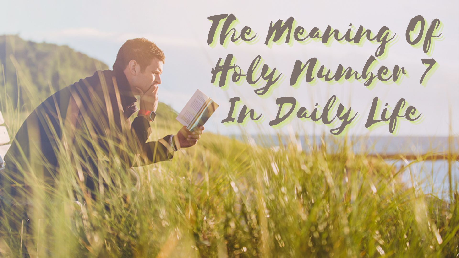 A man reading a Bible while sitting in the grass