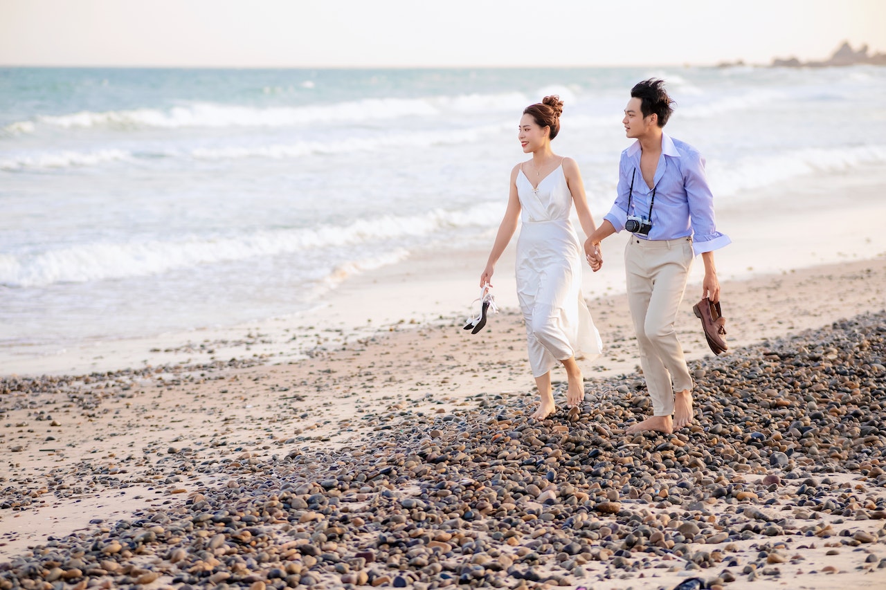 Couple Walking on Rocky Beach