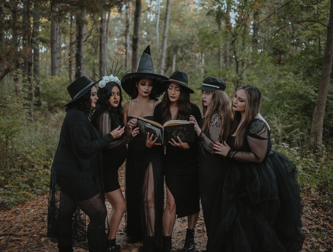 Group Of Witches Reading Spell Book