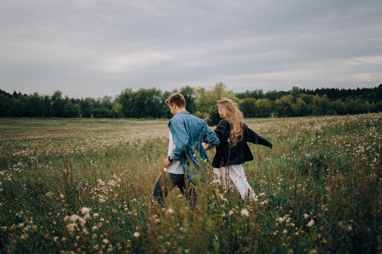 Couple Running on Field