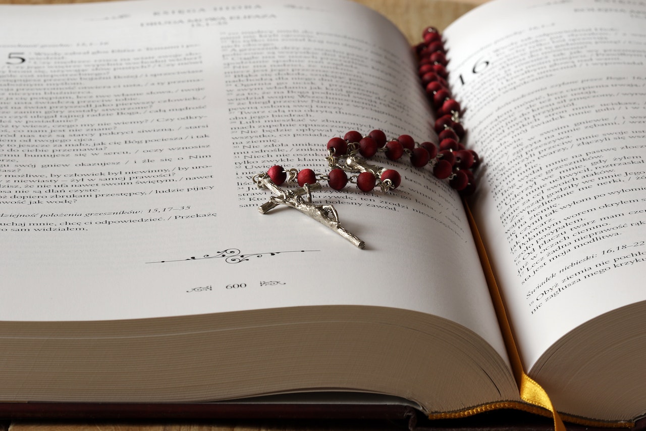 Rosary on Top of Opened Bible
