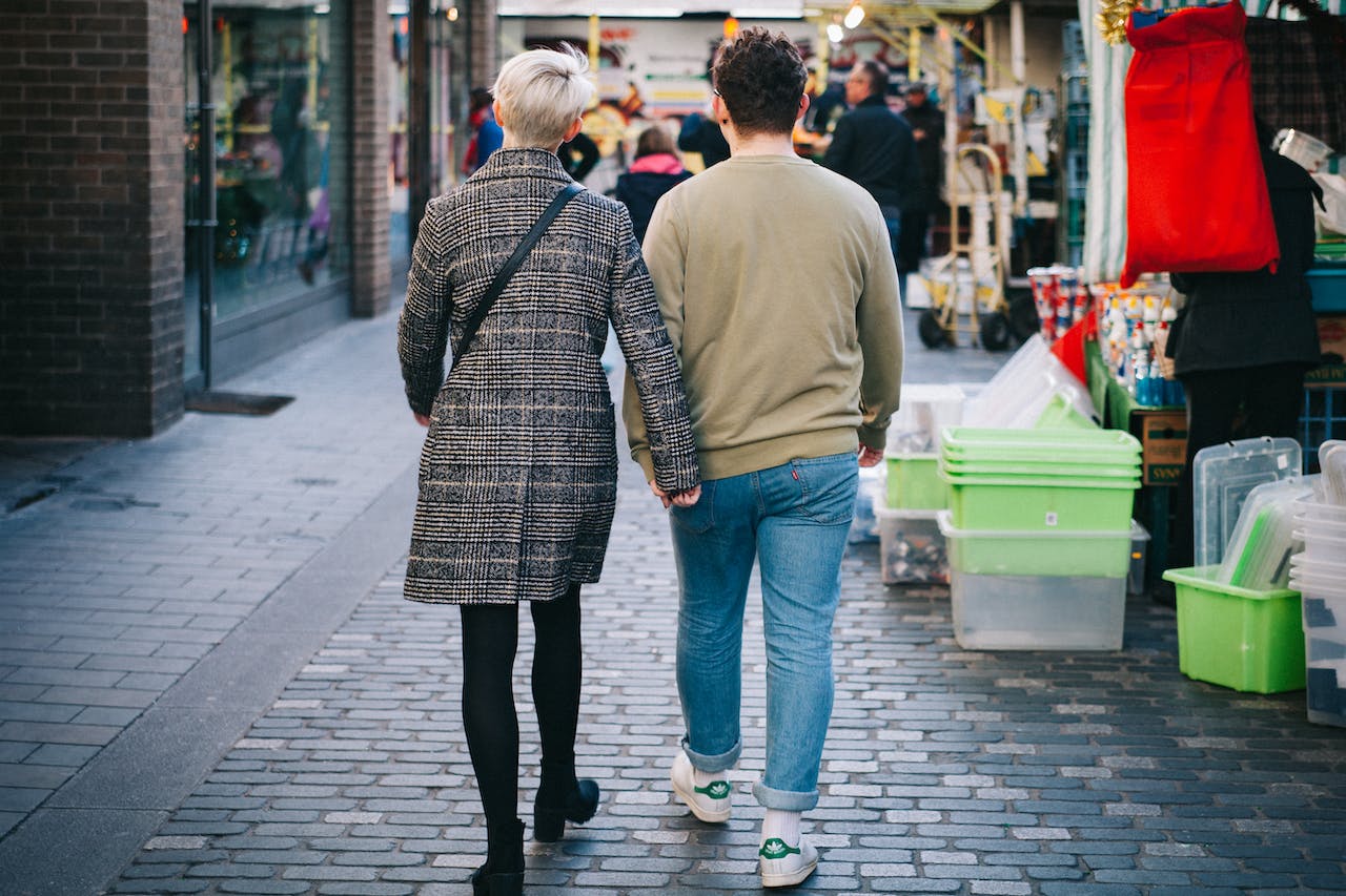 Man and Woman Walking on an Alley