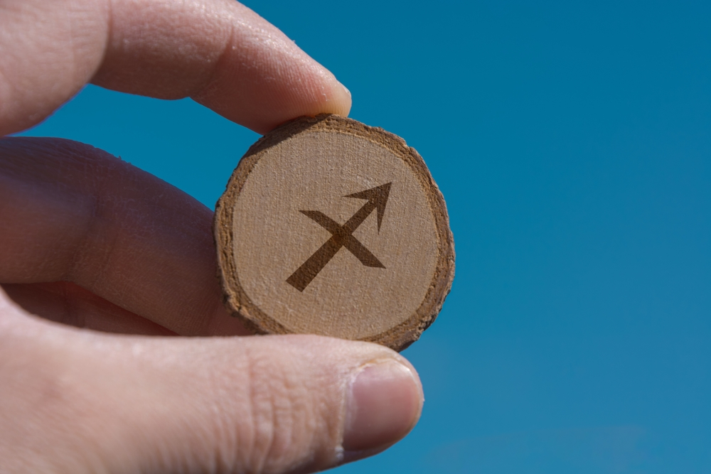 Sagittarius odiac sign engraved in wood.